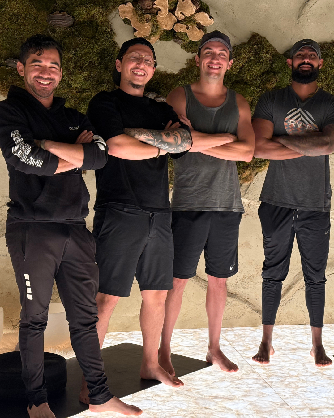 Tristan standing with men during a workshop gathering