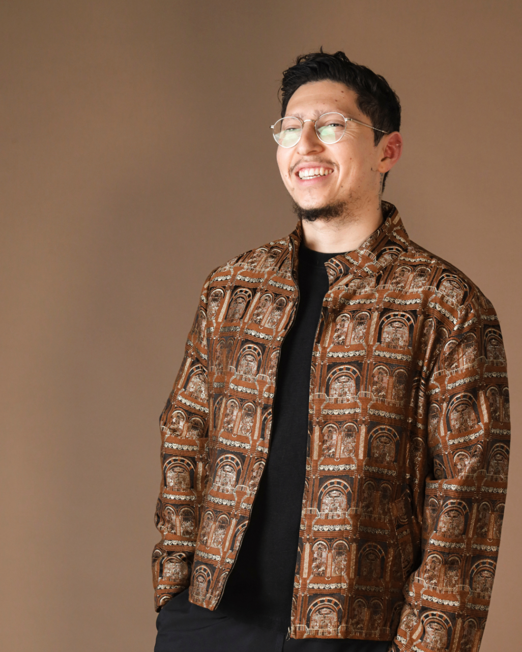 Portrait of Tristan smiling in a patterned jacket