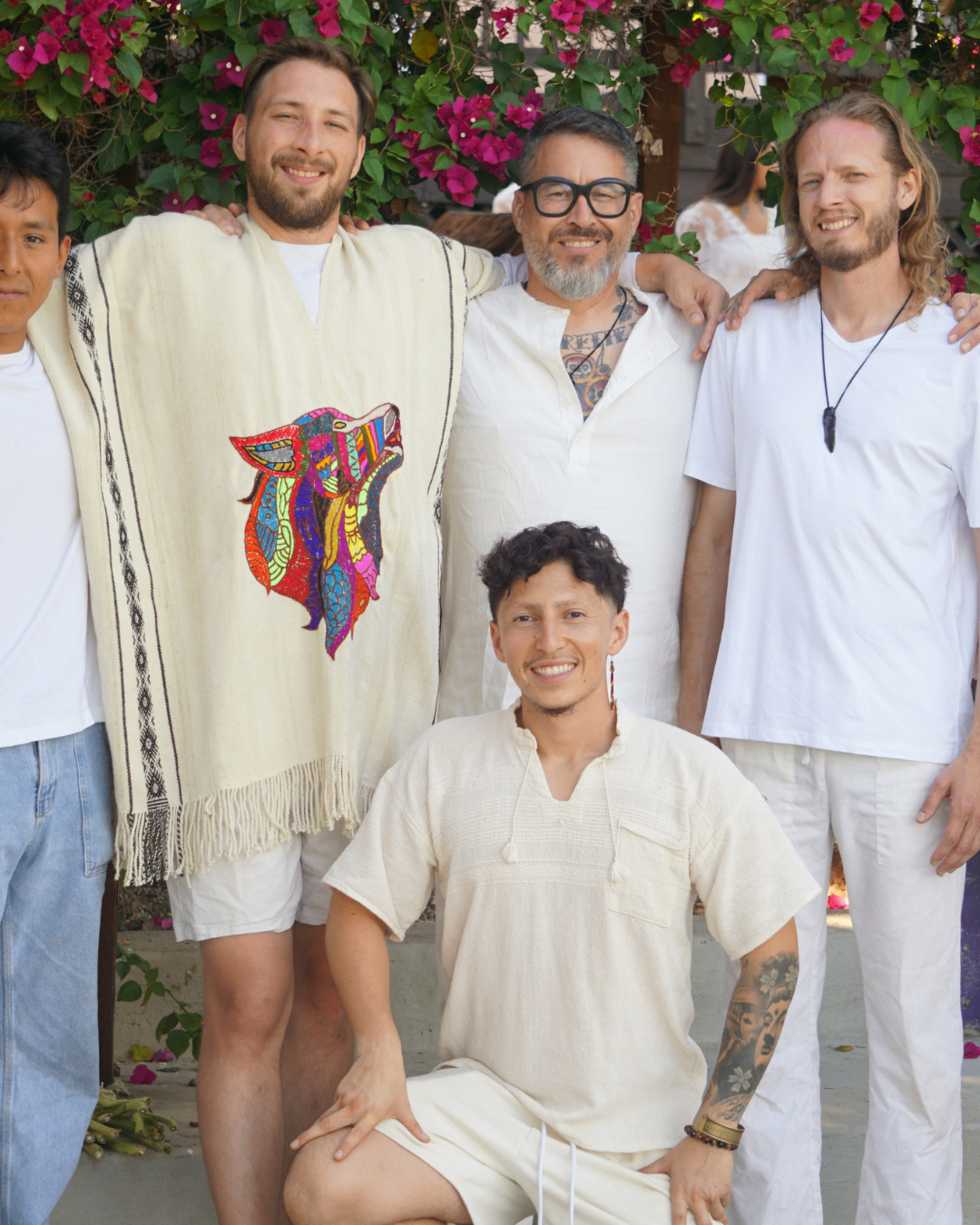 Tristan with community members in white ceremonial clothing