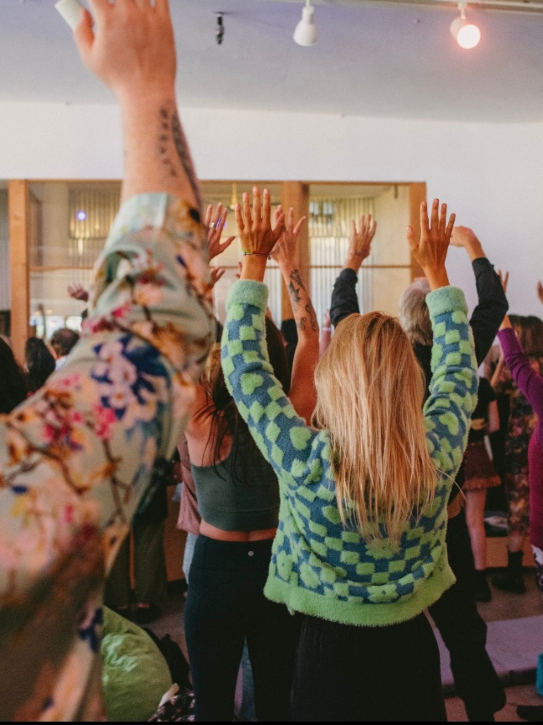 Guests raising their hands together in ceremony