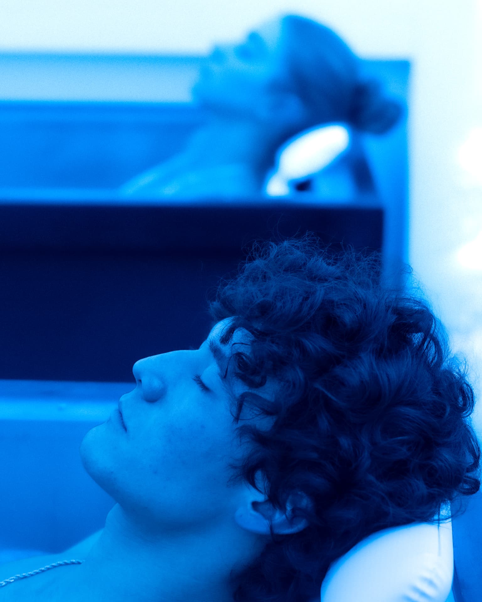 A man resting in the cold plunge at Quantum Wellness Spa