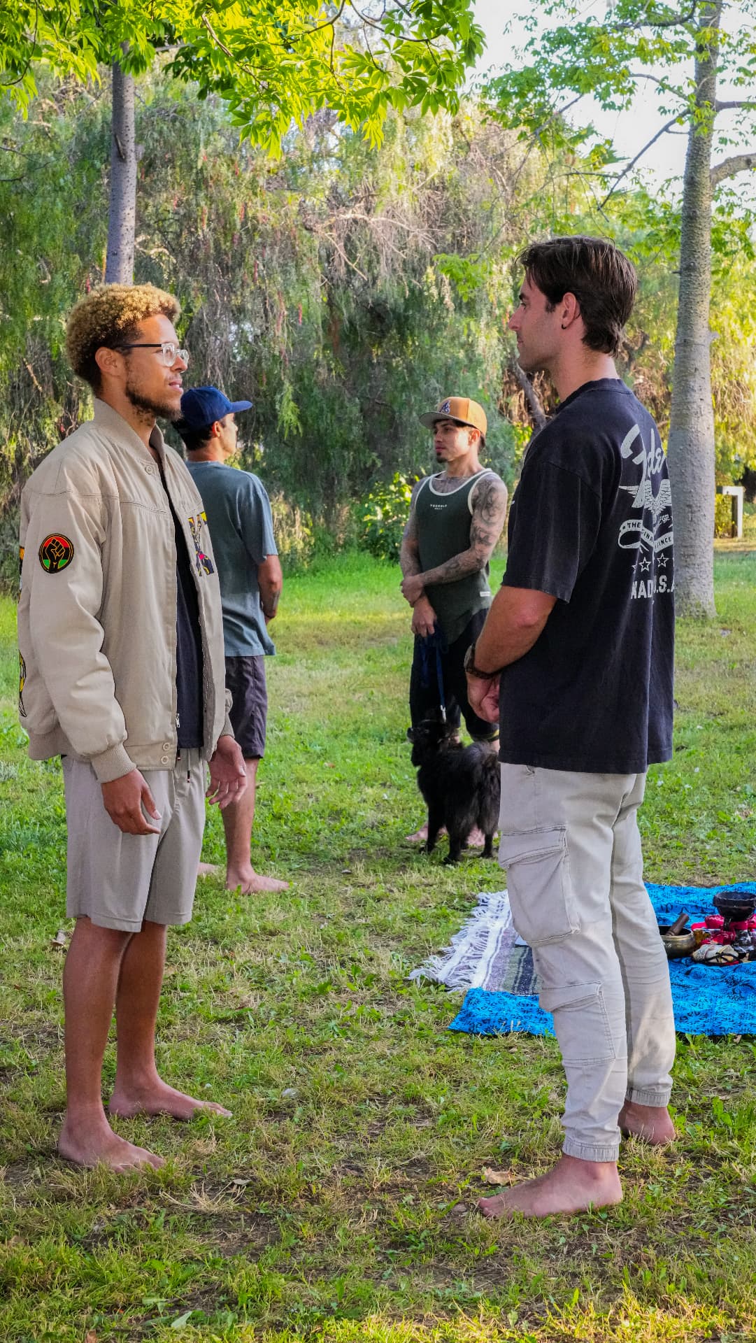 Men standing in circle outdoors on the land