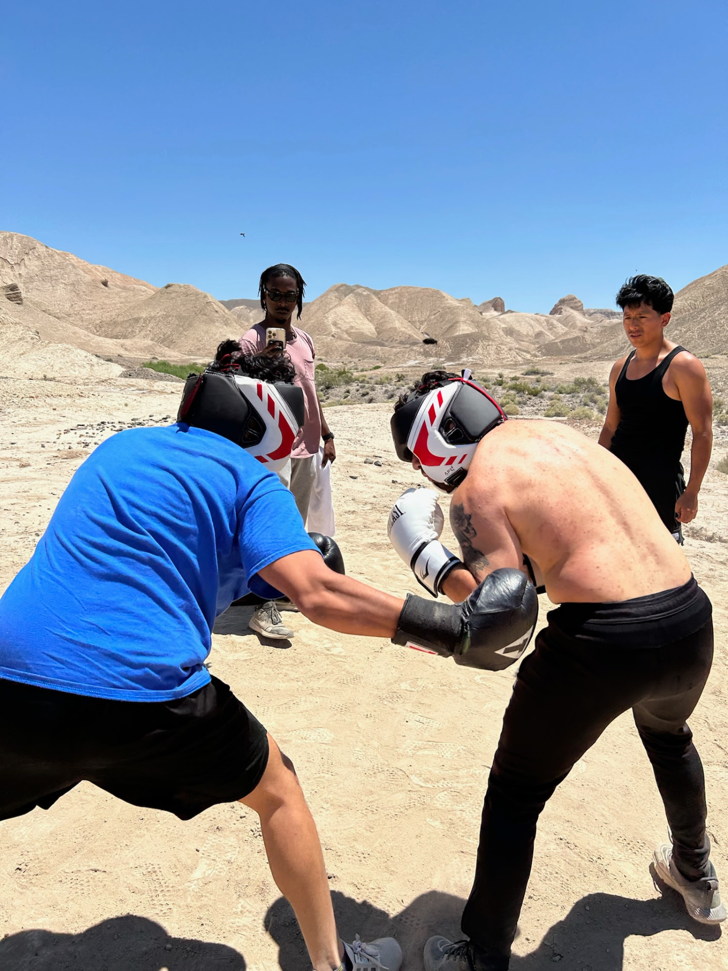 Men sparring together in the desert